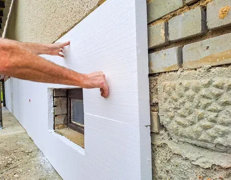 Foam insulation panel placed on an exterior wall during a retrofit